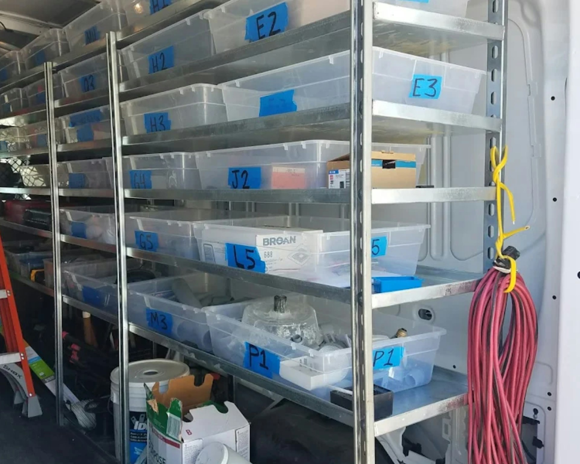 Shelves filled with labeled plastic bins and supplies.