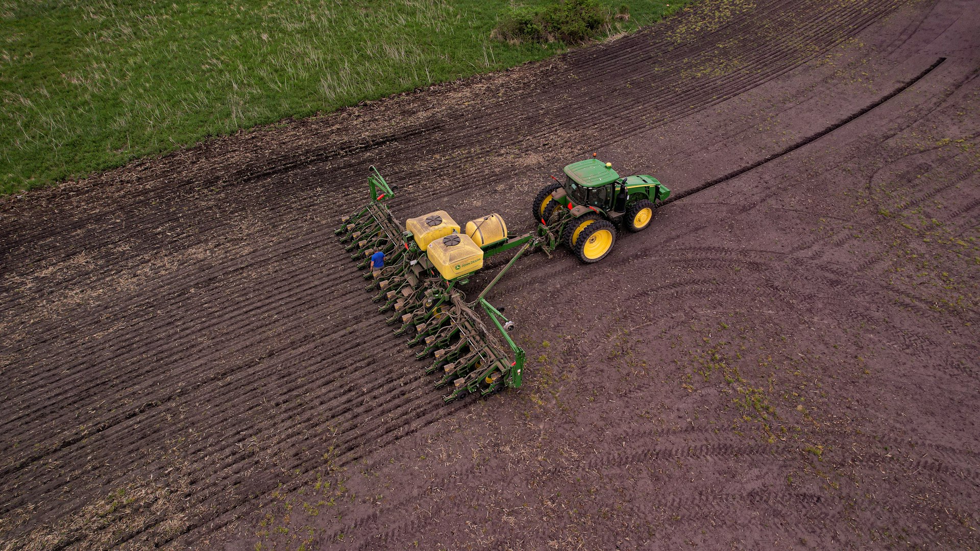 a tractor plowing a field in the middle of the day